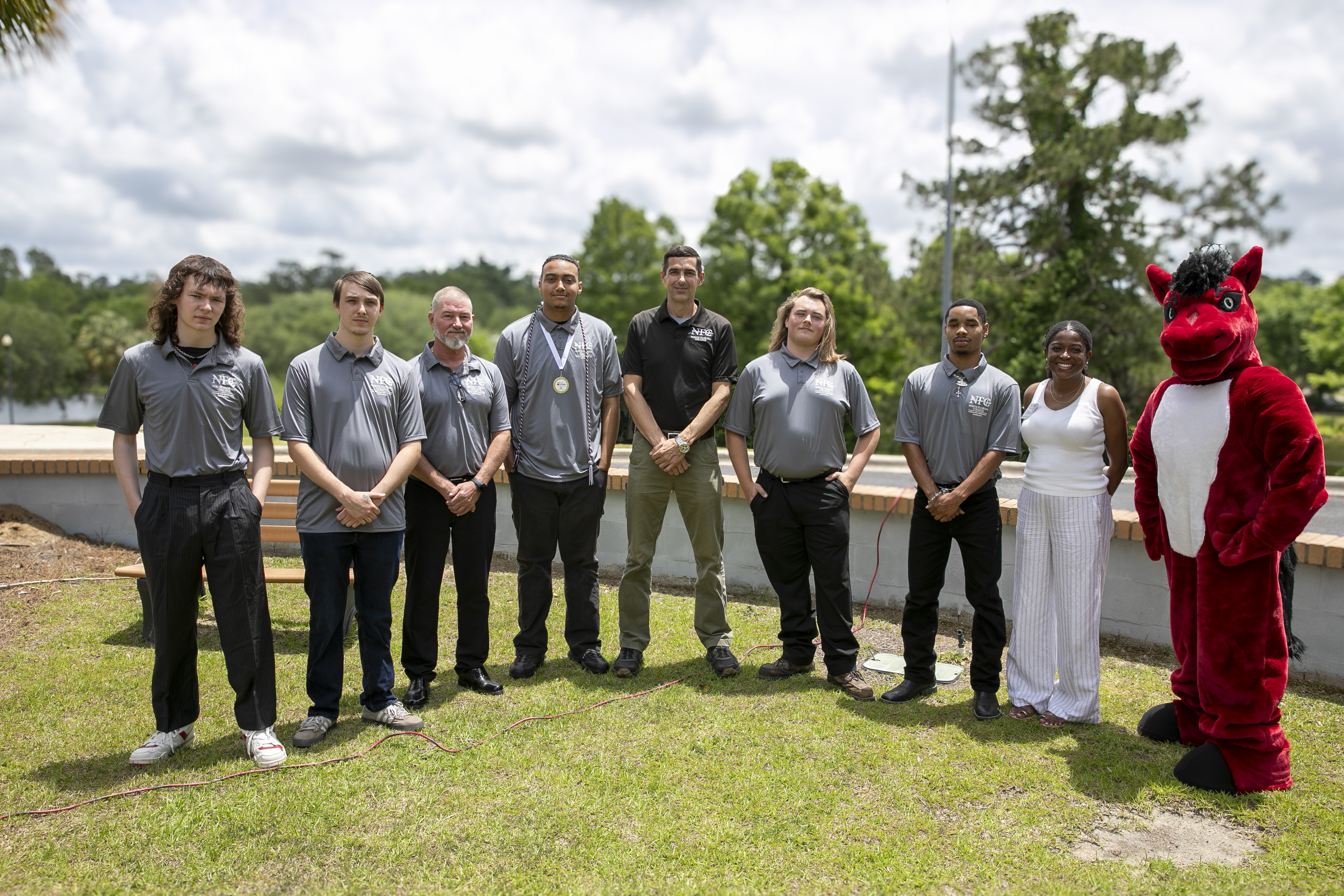 HVAC/R Class Photo L to R: Taner Holton, Christopher Lago, Ronny Hall, Jagger Whitaker, Instructor Jim Nuessle, Cameron Smith, Stavon McCreary, Director Deidra Dunnell and NFC mascot, Trailblazer. Not pictured: Aaron Philmon