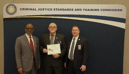 NFC Public Safety Director Rick Davis receiving certificate from the Criminal Justice Standards and Training Commission